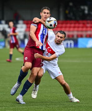 Eivind Helland of Norway in action against Berkay Yilmaz of