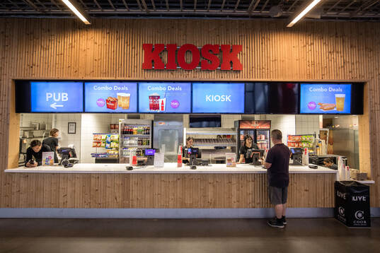 Glest med besökare vid en kiosk på Tele2 Arena