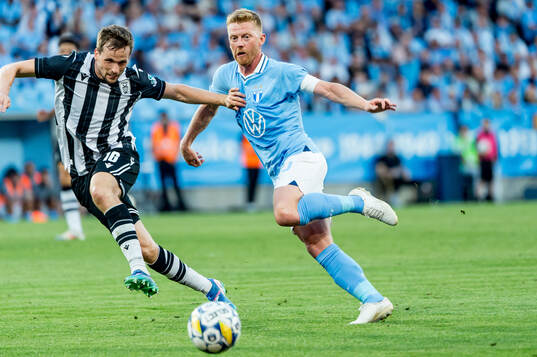 Tomasz Kedziora of PAOK and Anders Christiansen of Malmö FF