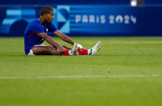 Loic Bade of France looks dejected