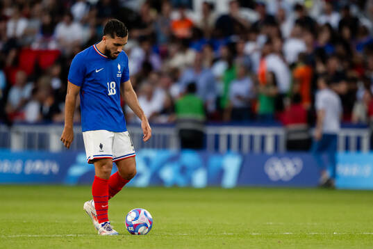 Rayan Cherki of France looks dejected