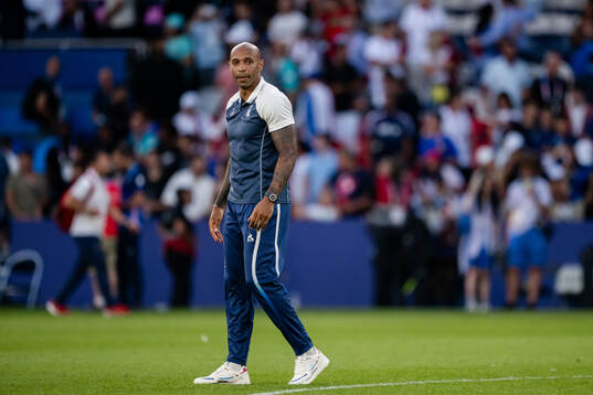Head coach Thierry Henry of France looks dejected
