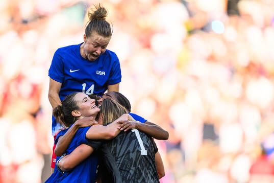 Emily Sonnett and Alyssa Naeher of USA celebrate with