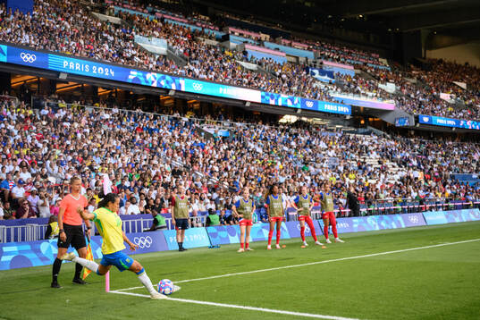 Marta of Brazil and assistant referee Almira Spahic in the