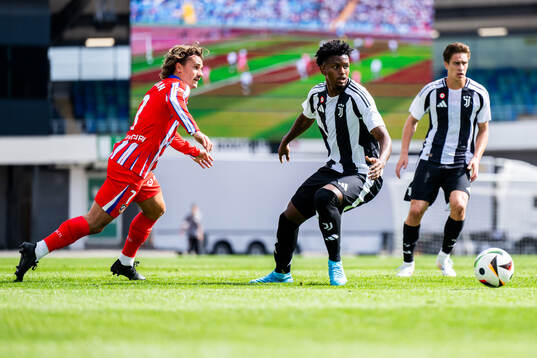 Antoine Griezmann of Atletico Madrid and Juan Cabal Murillo