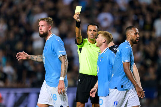 Pontus Jansson of Malmö FF receives a yellow card from