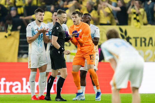 Niko Galesic and goalkeeper Martin Zlomislic of Rijeka