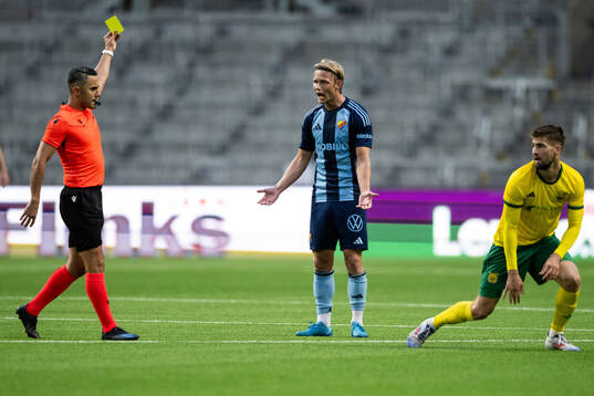 Tobias Gulliksen of Djurgården receives a yellow card from