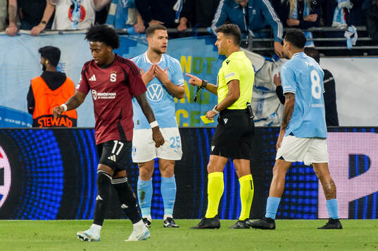Gabriel Busanello of Malmö FF receives a yellow card from