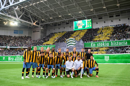 Hammarbys spelare framför supportrarnas tifo