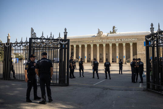 A police officer pass by outside of Tofiq Bahramov
