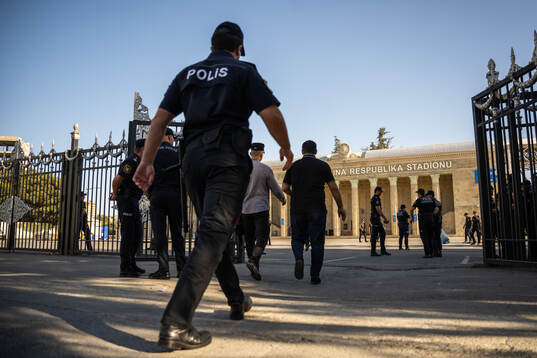 A police officer pass by outside of Tofiq Bahramov