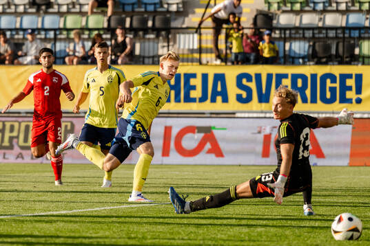 Daniel Svensson of Sweden scores the 1-0 goal behind