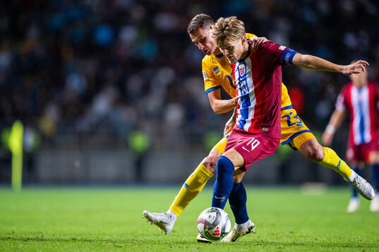 Martin Ødegaard of Norway and Islam Chesnokov of Kazakhstan
