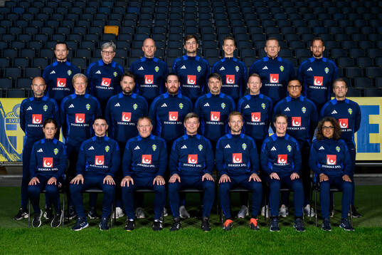 Staff of the Swedish men’s national team pose for a team
