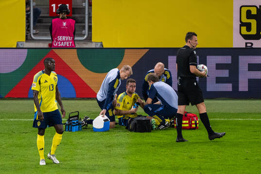 Gabriel Gudmundsson of Sweden receives medical attention