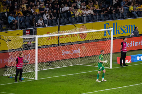 Safety stewards next to the goal of goalkeeper Viktor