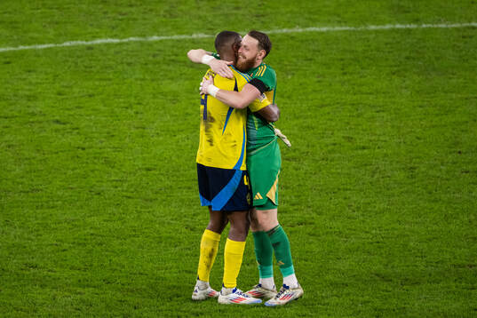 Isak Hien and goalkeeper Viktor Johansson of Sweden