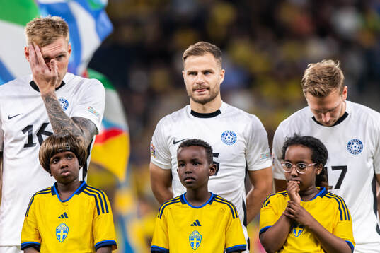 Mascots in front of players of Estonia