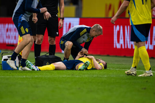 Gabriel Gudmundsson of Sweden receives medical attention