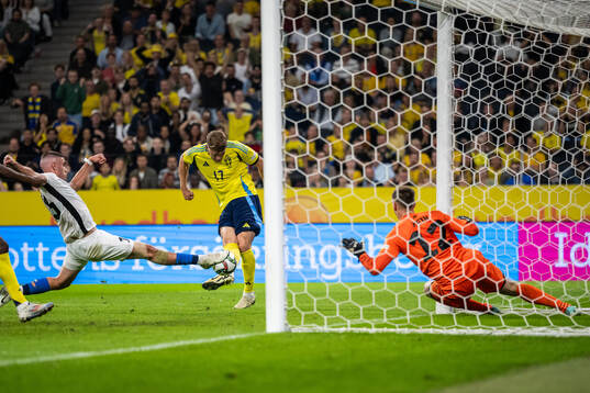 Viktor Gyökeres of Sweden scores 1-0 behind goalkeeper