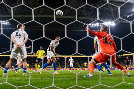 Alexander Isak of Sweden scores 2-0 behind goalkeeper Karl