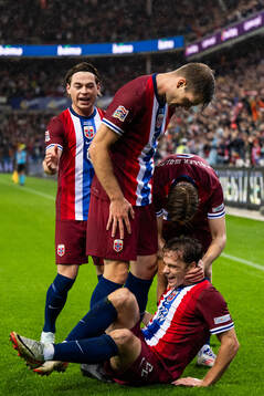 Felix Horn Myhre of Norway celebrates with team mates