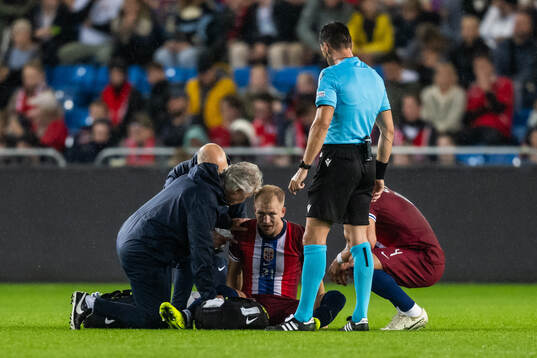 Andreas Hanche-Olsen of Norway receives medical attention