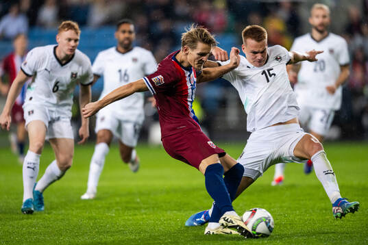 Martin Ødegaard of Norway and Philipp Lienhart of Austria