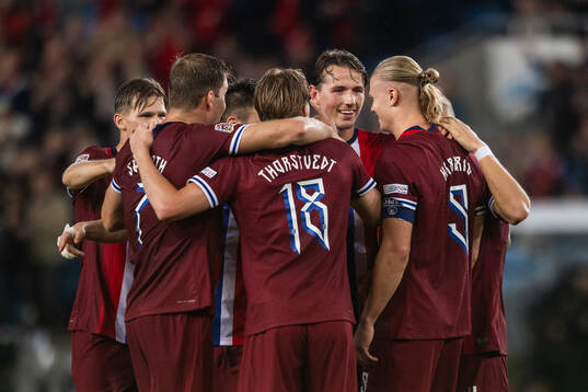 Erling Braut Haaland of Norway celebrates with Sander Berge