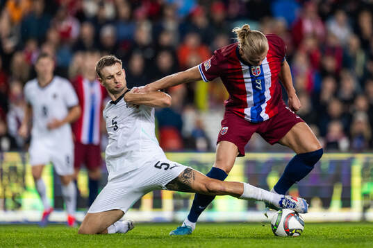 Stefan Posch of Austria and Erling Braut Haaland of Norway