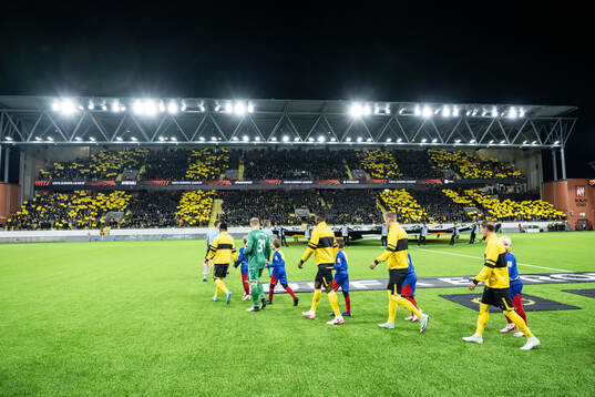 The teams enters the soccer field