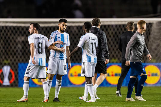 Abdellah Zoubir and Maksim Medvedev of Qarabag look dejected