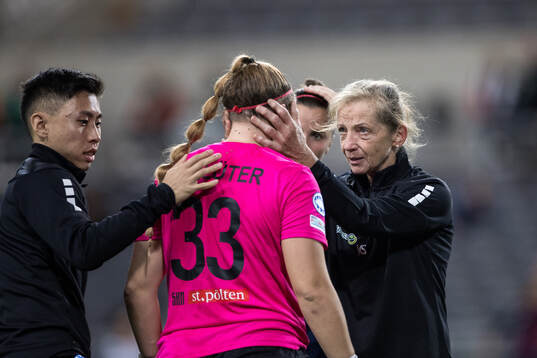 Goalkeeper Carina Schluter of St Pölten receives medical