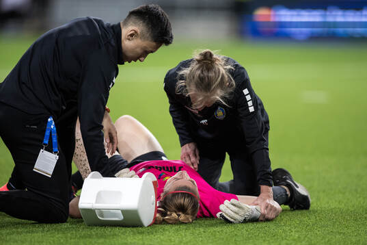Goalkeeper Carina Schluter of St Pölten receives medical