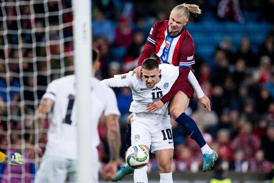 Timi Elsnik of Slovenia and Erling Braut Haaland of Norway
