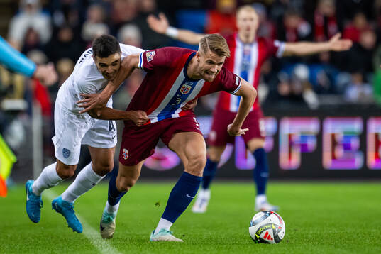 Dejan Petrovic of Slovenia and Kristoffer Ajer of Norway