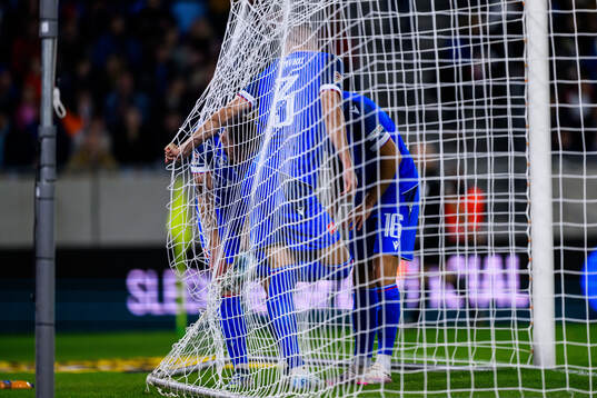 Denis Vavro of Slovakia is stuck in the net