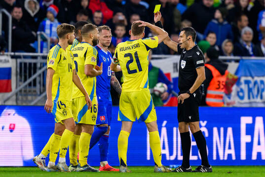 Jesper Karlström of Sweden is shown a yellow card