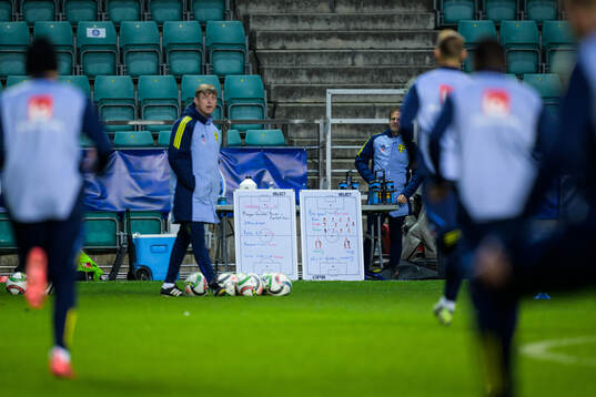 Tactical boards behind head coach Jon Dahl Tomasson of the