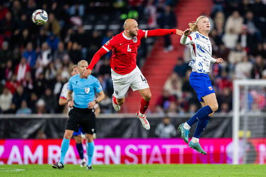 Gernot Trauner of Austria and Erling Braut Haaland of Norway