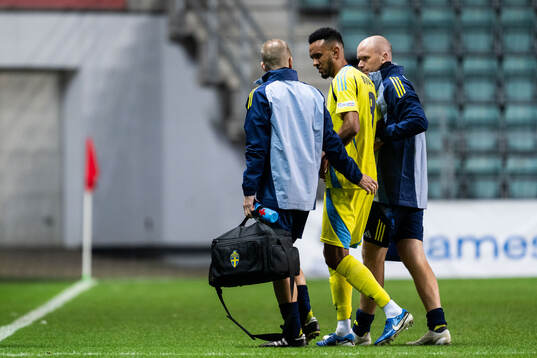 Alex Douglas of Sweden leaves the pitch injured