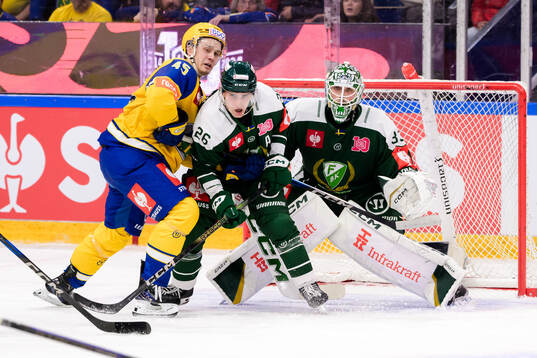 Axel Sandnes of Storhamar and Joel Nyström and goaltender