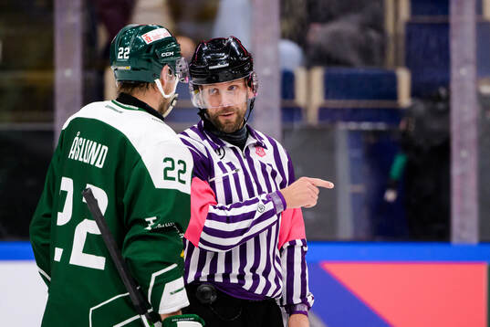 Per Åslund of Färjestad  and referee Marcus Linde