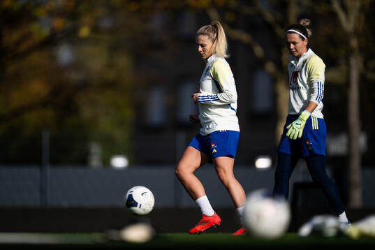 Rebecka Blomqvist and goalkeeper Jennifer Falk of the