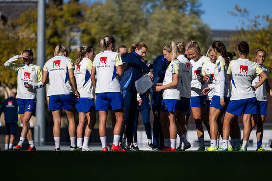Physio Jenny Larsson pours water for Rebecka Blomqvist of