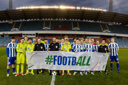 The players from both team pose for a photo