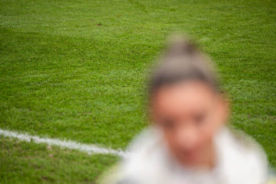 The grass of the pitch is seen behind Johanna Rytting