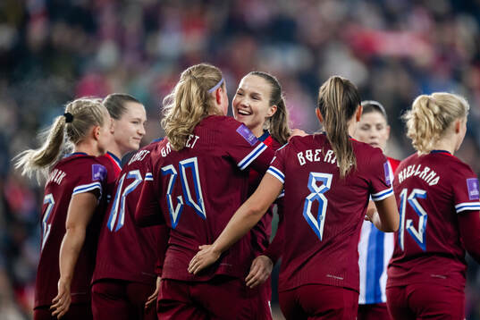 Signe Gaupset and Guro Reiten of Norway celebrate the 7-0