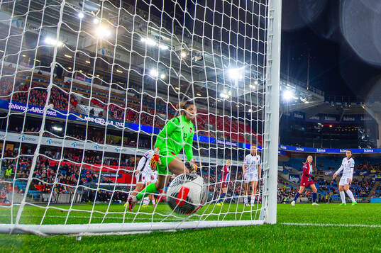 Frida Maanum of Norway scores the 1-0 goal past goalkeeper
